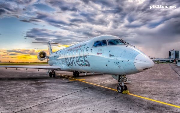 normal_airplane_in_an_airport-wide